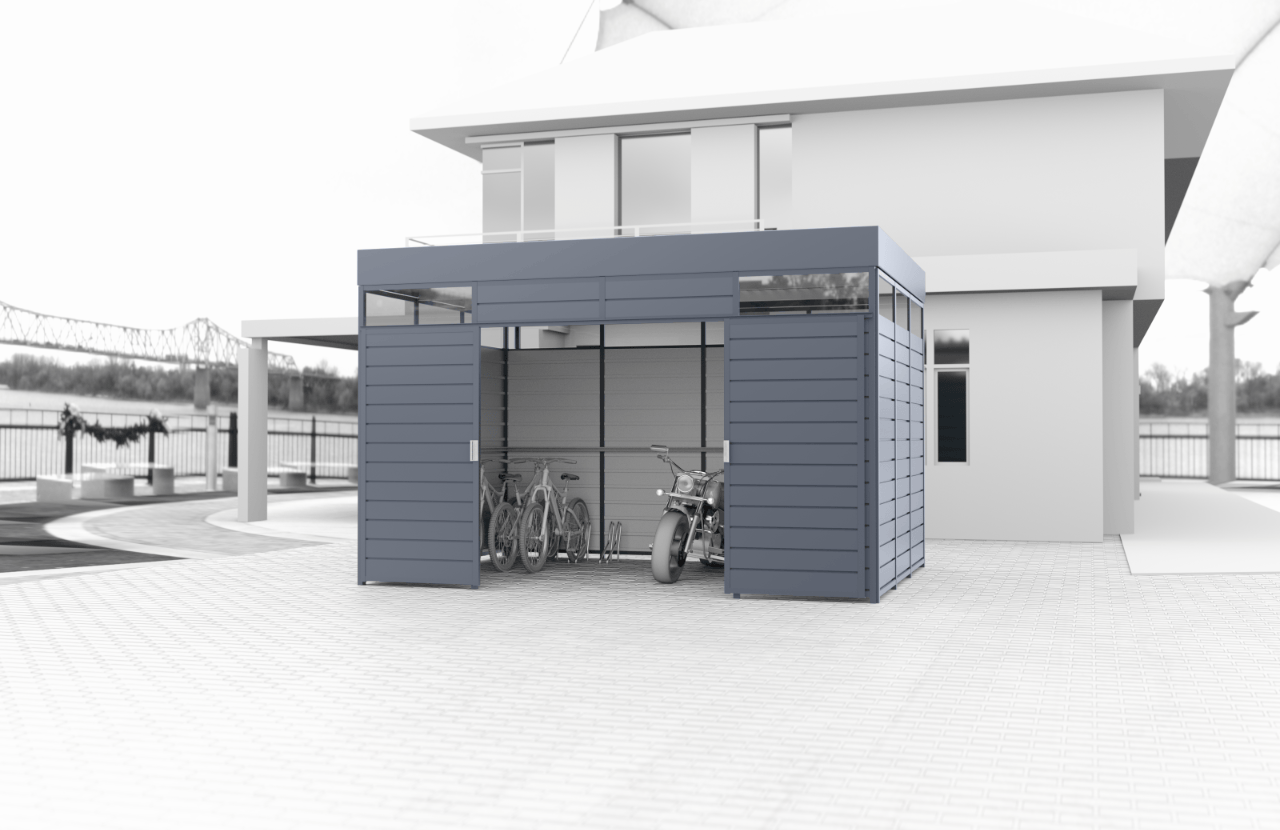 Graue Fertiggarage mit Motorrad und Fahrrädern darin, die neben dem Haus auf dem Bürgersteig errichtet wurde